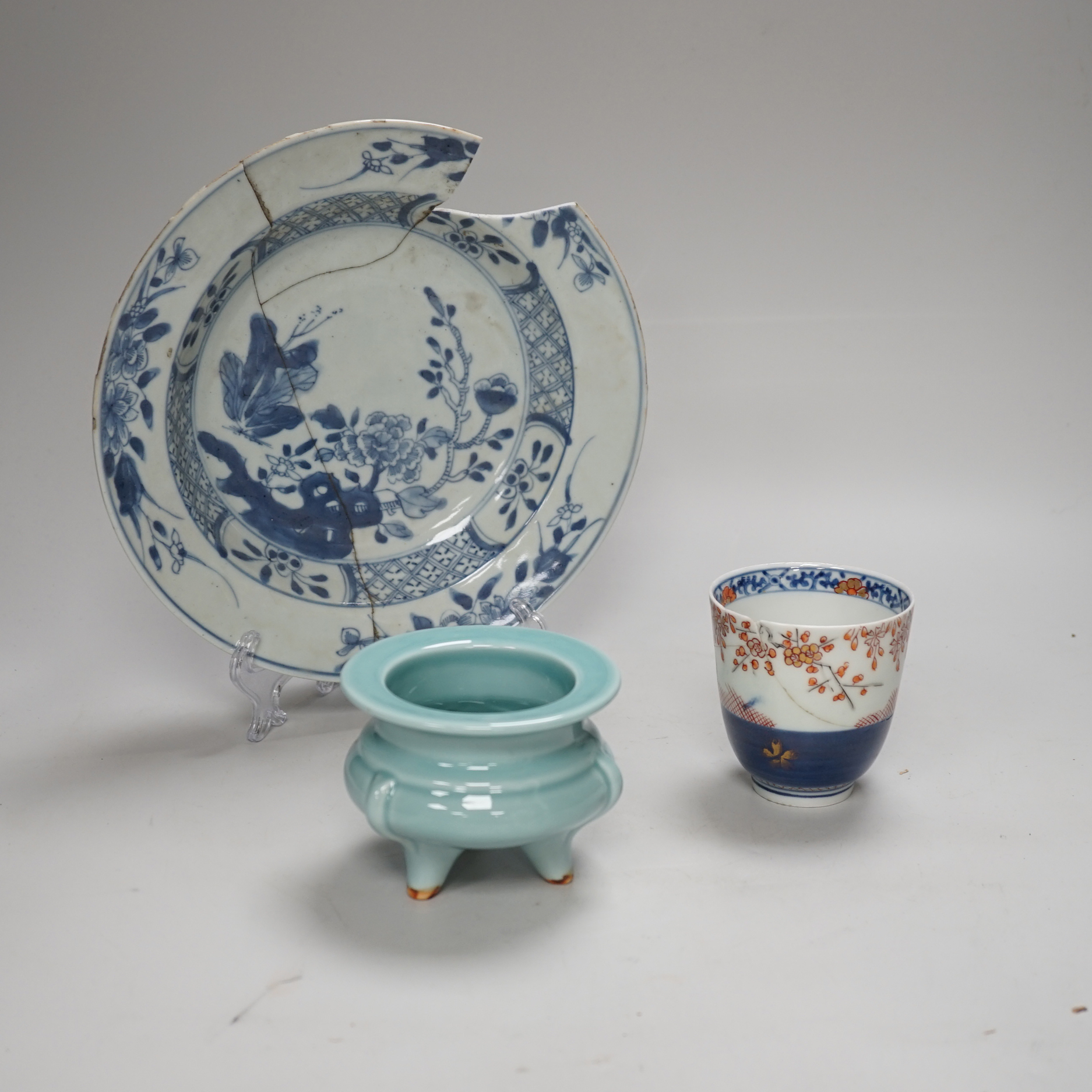 An 18th century Chinese export blue and white dish, celadon glazed tripod censer (20th century) and a Japanese Arita teacup